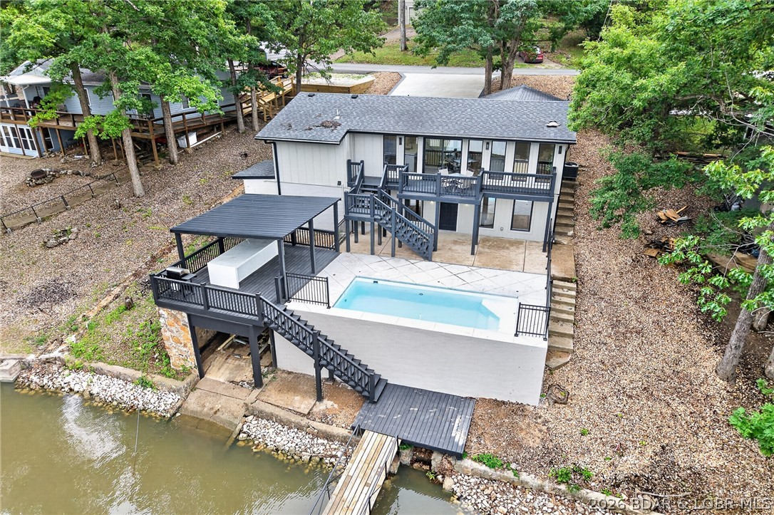 LAKE LIVING AT ITS FINEST! Spectacularly remodeled waterfront retreat in Sunrise Beach, perfectly positioned on a peaceful no-wake cove with a sparkling in-ground pool for the ultimate lake lifestyle. Effortless entertaining & everyday relaxation, filled with natural light & showcases fresh interior & exterior paint throughout. Inviting Great Room with fireplace flows seamlessly into the beautifully reimagined chef’s kitchen featuring a dramatic waterfall quartz eat-in island, stainless steel appliances & pantry. Retreat to the private primary suite offering a spa-inspired en-suite with double vanity & walk-in shower. 3 additional bedrooms and 2 full baths provide plenty of space for family and guests. Step outside & experience true resort-style lake living with multiple outdoor spaces including expansive deck, patio, covered patio, private dock & boat slip—perfect for sunset evenings, boating days & lakeside gatherings. Excellent location with easy access off the main road: new blacktop leading to the property. Oversized double driveway offers abundant parking for guests. Conveniently located near premier lake dining, entertainment and all the amenities Sunrise Beach has to offer.
