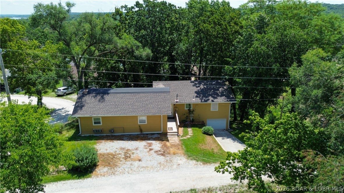 ***POSSIBLE LEASE OR LEASE/PURCHASE OPPORTUNITY***MOTIVATED SELLER—BRING YOUR OFFER! Why pay lakefront prices when you can enjoy the same incredible Lake of the Ozarks lifestyle for a fraction of the cost? This spacious, well-maintained 2-bedroom, 2-bath home offers approximately 1,800 square feet of comfortable living space in a peaceful lake community with private water access. Spend your days boating, fishing, swimming, or soaking up the sun with exclusive access to the community boat ramp and shared dock. Launch your boat with ease, enjoy endless days on the water, then return home to relax in a quiet setting away from the busy lake traffic. Inside, you'll love the open, spacious layout that's perfect for entertaining. Whether you're searching for a full-time residence, a weekend getaway, or an investment opportunity, this property checks all the boxes. Located just minutes from popular waterfront restaurants, marinas & some of the best fishing and boating the Lake of the Ozarks has to offer, you'll enjoy everything the lake is famous for—without the high taxes, maintenance, and premium price of lakefront ownership. Properties offering this combination of space & affordability!