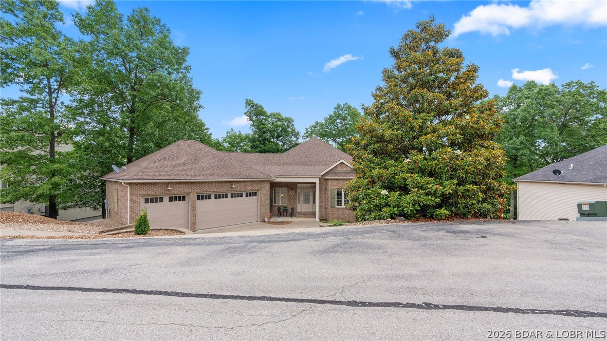 Luxury lake-view home and meticulously maintained—shows like new! Tucked away on a quiet cul-de-sac in a highly desirable community and great school district, this turnkey property offers the perfect blend of comfort, space, and lake living. The open-concept floor plan features a stunning living room with gas fireplace, built-in bookshelves, entertainment nook, and seamless flow into the kitchen and dining area—ideal for entertaining family and friends. The spacious primary suite includes a jetted tub, walk-in shower, and large walk-in closet. Two bedrooms are conveniently located on the main walk-in level, 3 bedrooms are located on the lower lever with the potential for an additional unfinished room for an office. Enjoy outdoor living year-round from the upper screened-in porch overlooking beautiful lake views. Additional highlights include a big 3-car garage, excellent internet service, and a new roof installed in 2020. 12X 34 Dock slip included  on the 2 MM of the Big Niangua, making lake access easy and convenient. Enjoy all of the amenities including clubhouses, community pools, tennis courts, playgrounds, and more. Call for a private showing today!
