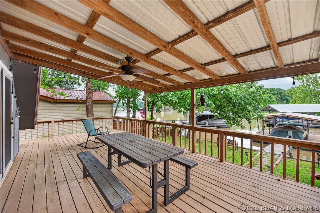 Charming A-frame lakefront retreat in Ivy Bend at the 58-mile marker! This inviting 3-bedroom, 1.5-bath lake home offers a cozy open layout perfect for weekend getaways, full-time living, or entertaining family and friends. One bedroom and the half bath are located in a separate guest space with a private entrance, creating the perfect setup for visitors, additional sleeping quarters, or flexible use space. Step outside and enjoy lake views from the spacious deck, gather around the fire pit in the evenings, and take advantage of the private dock featuring a boat lift and swim dock for endless days on the water. Conveniently located in the same cove as the popular Surfside Bar & Grill, making lakeside dining and entertainment just minutes away by boat or car. A local hardware store is also located within approximately one mile for added convenience. Whether you're looking for a relaxing weekend escape, vacation rental opportunity, or full-time lake residence, this property combines comfort, charm, and the best of the Lake of the Ozarks lifestyle.
