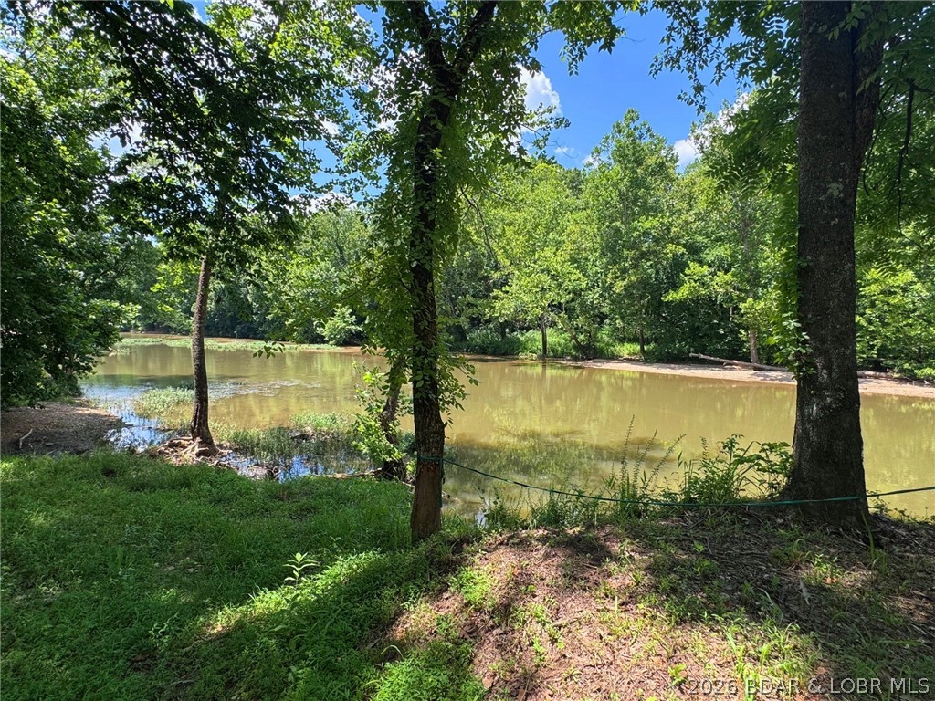Experience the beauty and serenity of riverfront living in this exceptional newer construction home tucked away on 9.6 private acres along the Little Niangua River. With 550 ft of pristine river frontage, this remarkable property offers over 3,240 sq ft of thoughtfully designed living space featuring  Main Level Living, 4 bedrooms, 3.5 baths, Master Suite w/Custom Walk In Tile Shower & Jetted Tub, Open Floorplan, Black Granite Countertops in Kitchen w/walk in pantry, 2 laundry areas,  soaring vaulted ceilings, and oversized windows capturing stunning natural views in every direction. Enjoy mornings on the wrap-around deck, evenings on the expansive covered patio, and endless outdoor adventures including fishing, swimming, floating, and hunting. The ultimate private retreat for those seeking peace, nature, and luxury living. Owner Financing Available. Seller would consider making a trade for another property.