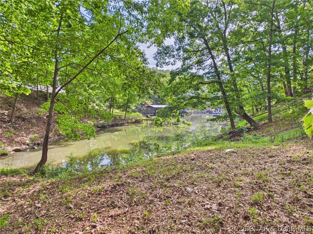 Lakefront living without the well and septic headache. This Sunrise Beach lot offers something buyers do not find every day at this price point: city water, city sewer, lakefront, and convenience. Situated in a quiet cove with minimal wave action, the property includes 90 feet of waterfront and 5–6 feet of water depth during the recreational season. The lot is partially leveled, dockable, and positioned in an established area close to shopping, dining, and local attractions. With multiple marinas slips and boat ramps within roughly 10 minutes. This is a great spot for someone wanting lake access, future build potential, and city utilities already available.