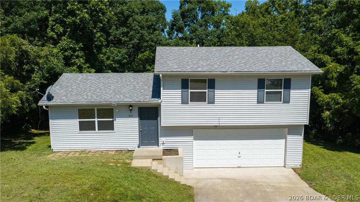 Welcome home to this charming 3-bedroom, 1-bath split-level home located in a desirable neighborhood in Camdenton! Whether you're looking for your first home, downsizing, or searching for a great investment opportunity, this property checks all the boxes. The functional floor plan offers comfortable living spaces and is move-in ready, allowing you to settle in with ease. A spacious 2-car garage provides plenty of room for parking, storage, or hobbies, while the nice lot offers space to enjoy the outdoors. Conveniently located near shopping, dining, schools, and everyday amenities, you'll love the combination of neighborhood charm and easy access to everything Camdenton has to offer. Public water and community sewer add to the convenience of low-maintenance living. Don't miss this fantastic opportunity to own a home that's perfect for homeowners and investors alike!