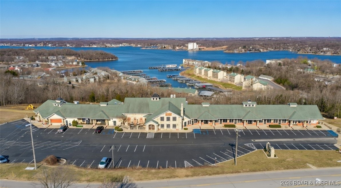 Very unique opportunity to own one of the few Commercial properties on Horseshoe Bend. This 46,000 sqft shopping center on over 4 Acres with great Lake Views has loads of potential for the right investor. The main level currently has Two successful operating restaurants, one mexican and one Bar + Grill, both are well established. The Anchor point of the mall is currently vacant and features a nearly 13,000sqft two level space that was previously a high end steak house and is ready to run as a restaurant or remodel to suit your needs. The rest of the main level is sectioned or ready to section into 9- 20x50 units. Three units are complete, one for offce space and two combined for retail space. The other units are unfinished and 5 can be combined. On the back side of the building there are also 8 20x50 units. 3 are unfinished and not separated, ready to build out as needed. 4 units are rented. There is also 5800sqft of unfinished storage on the other side of the building that is ready to build out and could be separated. With 4 condo complexes within 1/4 mile and being in between Lodge of the Four Seasons and Camden on the Lake makes this a prime spot.