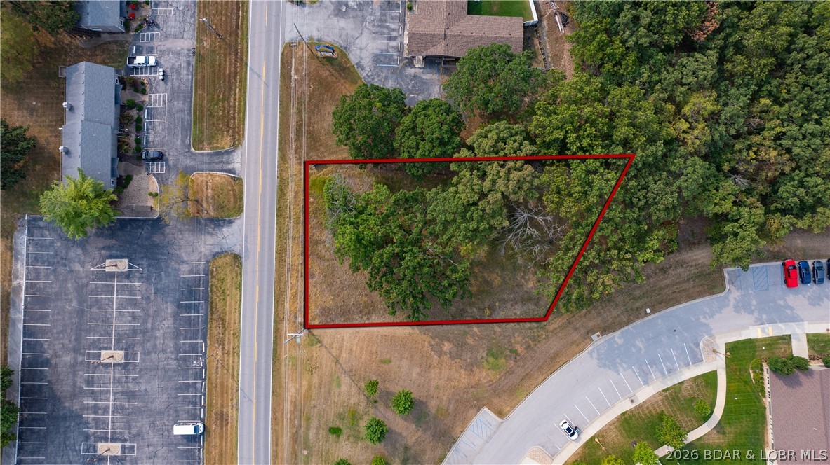 Exceptional commercial opportunity in a high-growth corridor! This C-1 zoned property offers over 110 feet of prime Highway KK frontage, with a MODOT-approved entrance plus secondary access for excellent visibility and easy customer flow. Sitting on just over half an acre, it includes city water, sewer, and electric—ready for development. Located in the heart of Osage Beach near Lake of the Ozarks, this site is surrounded by established neighborhoods, condos, and marinas. Positioned across from Jeffries Fine Dining and next to KK Jewelers, it benefits from steady traffic and strong local activity. Just minutes from the Hwy 54/KK overpass and close to Margaritaville Lake Resort Lake of the Ozarks, golf courses, and popular attractions, this location stays busy year-round. Flexible C-1 zoning supports retail, dining, office, or entertainment. A prime opportunity to build in one of the lake’s most desirable commercial areas.