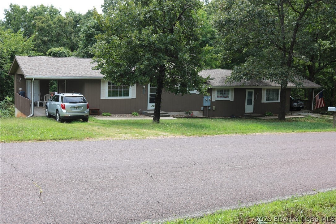 GREAT investment opportunity and location. Close to downtown Laurie Mo Morgan County USA. Duplex BOTH SIDES Currently rented. Well maintained condition fresh paint on the exterior and new architectural roof. Poured concrete crawl space foundation and concrete floored carports on each end blacktop to the door.