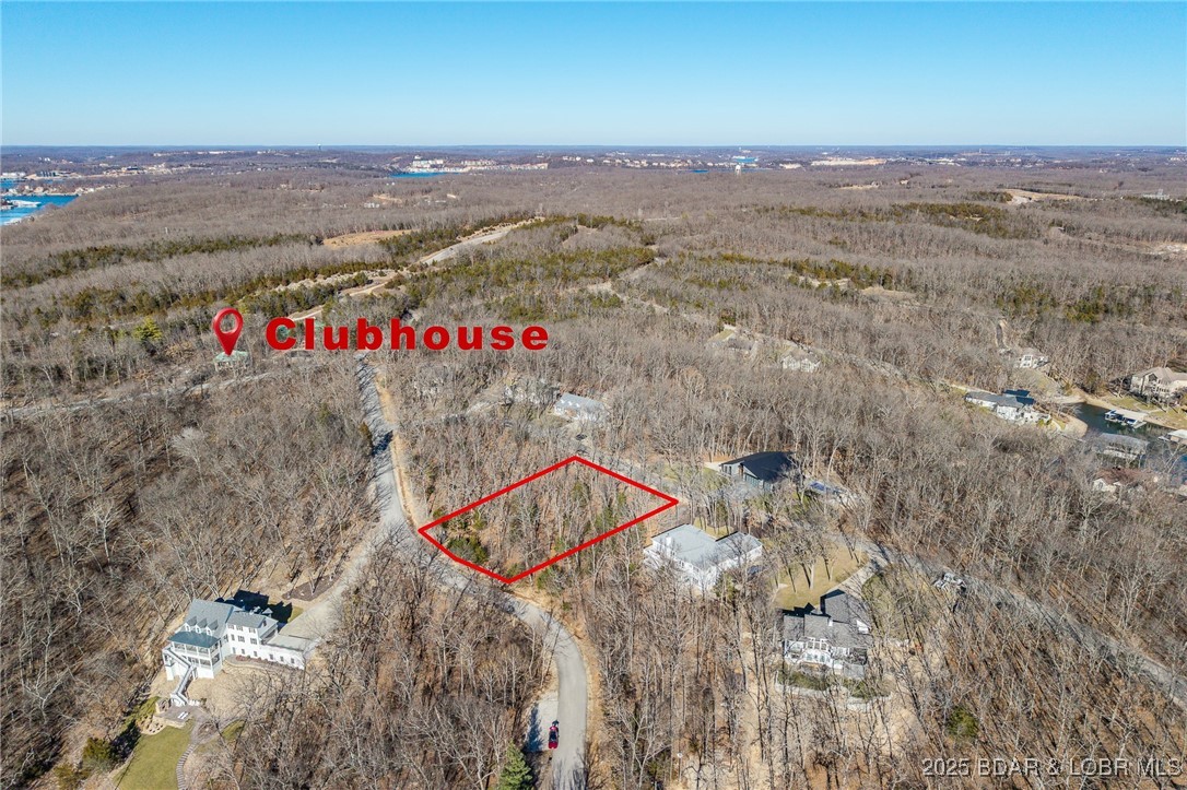 Enjoy the charm of ever-changing lake scenery with this Seasonal View lot at The Villages at Shawnee Bend. Partial lake views emerge throughout the year, offering a unique connection to the surrounding landscape while maintaining privacy and natural beauty. The community sets itself apart with a grand waterfall entrance and an impressive lineup of amenities, including a clubhouse, resort-style pool, championship tennis courts, and pickleball facilities. Parks, and playgrounds enhance the lake lifestyle, while paved streets and underground utilities provide modern convenience. This lot is ideal for a full-time residence or a relaxing weekend escape.