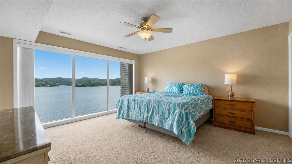 The VIEW is what sets this condo apart! Located at Windsor Bay Condominiums, this turn-key 3 BATH / 3 BATH end-unit offers breathtaking panoramic views of the Osage 34MM from its spacious screened-in & covered deck—perfect for enjoying the lake in any season. End-unit positioning provides additional side windows, filling the condo with natural light while maximizing the incredible lake views. All 3 beds feature private bathrooms & the larger-than-average kitchen offers abundant cabinet & counter space, rarely found in condo living. Includes a 10x30 boat slip WITH lift, PWC space (dock 3/slip 2L) & a private storage closet just outside the front door. The complex has recently undergone major improvements including a new roof, new siding, new railings & freshly sealed parking lot. Coming soon is a new pool liner & renovated pool deck scheduled for Fall 2026. Enjoy the lakeside clubhouse featuring a full kitchen, fitness equipment, games, fireplace & stunning lake views. The elevated pool deck offers some of the best views in the complex, while the docks are protected by a wavebreak for added peace of mind. Captain Ron's is just around the corner along with many other lake favorites!