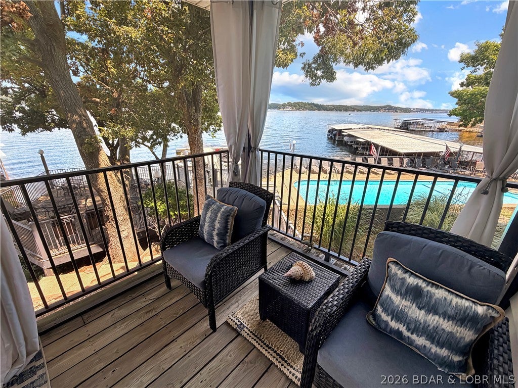 LOW ASSESSMENTS at just $337/month! Enjoy lakefront living in this inviting 2-bedroom, 2-bath condo at Woodcrest Condominiums, offering beautiful lake views and a great view of the community pool. The open floor plan keeps the lake in sight from the main living area, while the spacious deck provides the perfect place to relax, entertain, or enjoy the scenery. An included 11x28 boat slip makes lake access easy, and owners also enjoy use of the community pool and clubhouse. With its close-to-the-water setting, desirable amenities, included boat slip, and affordable monthly assessments, this condo is a great opportunity to enjoy the Lake of the Ozarks without the high carrying costs.