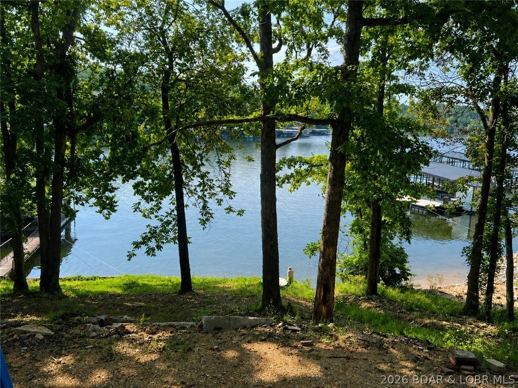 This beautiful building lot in Lick Branch Cove checks all the boxes! With a gentle slope, beautiful lake views, and deep, calm water, this property offers the perfect combination of lakefront conveniences. Even better, sewer and electric hookups are available for the lot, helping make the building process that much easier and affordable. Located in a peaceful cove while still offering convenient access to everything the Lake of the Ozarks has to offer, this is an ideal location for a full-time residence, weekend getaway, or investment property. Bring your plans and start building your Lake of the Ozarks dream! Look for our signs - the address on maps may take you too far into the cove.