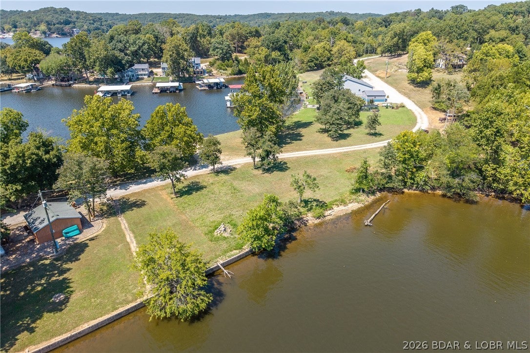 Available now!!! 9.5 acres to build your secluded dream home overlooking the beautiful Lake of the Ozarks! Also featuring a second 80' of flat, dockable lakefront just a walk down the road. Invision summer days with picnics/gatherings lakefront & quiet evening retreats to your cozy woodland home.  The possibilities are endless and restrictions are few! 
(Community well available)