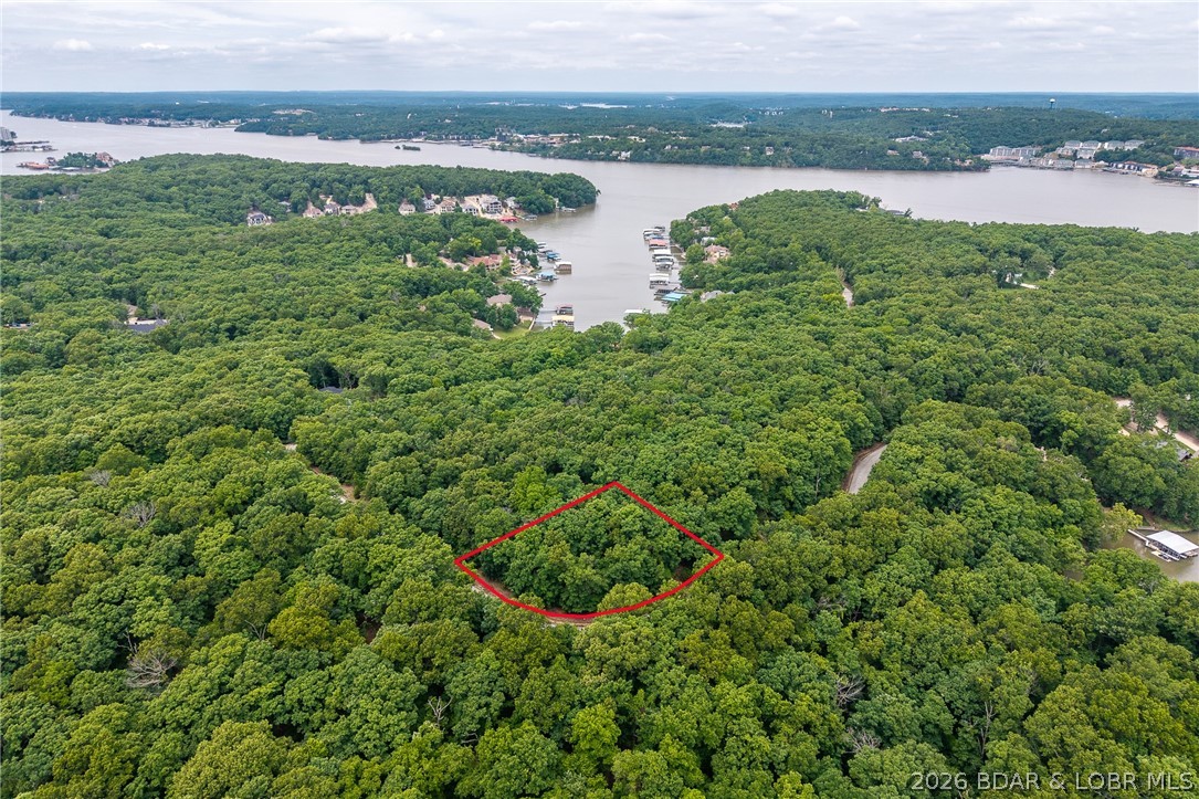 Build your dream home in the prestigious Porto Cima community at Lake of the Ozarks. Located on Grand View Drive, this beautiful second-tier homesite offers a peaceful setting with nearly an acre of ground and 249 feet of road frontage. The lot offers an ideal setup for a custom home with spacious outdoor living areas, and a great driveway entrance. 
Porto Cima is one of the lake’s premier luxury communities, home to the Jack Nicklaus Signature Golf Course, the private Porto Cima Yacht Club, marina access, and an unmatched lifestyle both on and off the water. Ownership also includes access to Four Seasons amenities including pools, playgrounds, boat ramps, campground, tennis/pickleball courts, and more. Whether you’re looking to build a full-time residence or a luxury lake retreat, this is an opportunity to own and stand out in one of the most sought-after communities at Lake of the Ozarks.