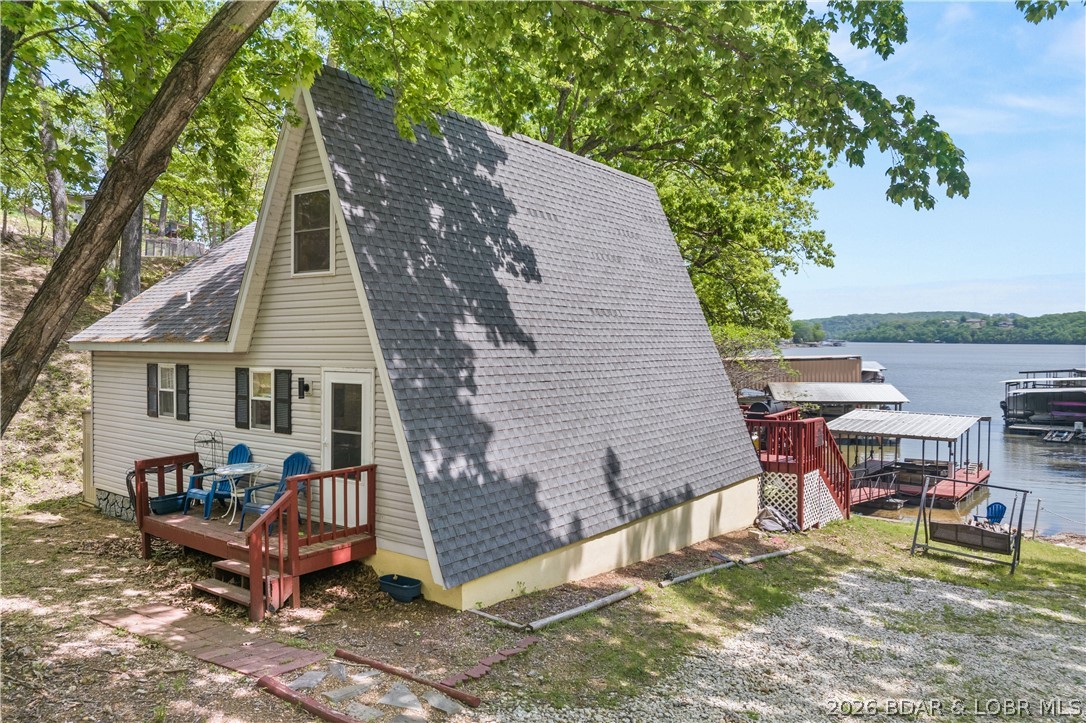 Escape to your private sanctuary in Sunrise Beach. Situated over half an acre at MM39, this cozy 2-bedroom, 1-bathroom A-frame is a lakefront treasure previously featured on HGTV’s Lakefront Empire. Perfectly positioned for both relaxation and profit, this home allows nightly rentals & comfortably sleeps eight, surrounded by mature trees & absolute tranquility. Inside, discover a bright, open-concept interior, freshly painted walls, new flooring, and updated lighting throughout. Modern essentials include a smart thermostat, newer windows/doors, and custom cabinetry. The living space flows effortlessly to a spacious, restored deck—the ultimate vantage point for breathtaking lake views and outdoor gatherings. Enjoy 80 feet of private lakefront with an easy walk to your private one-well dock, newly equipped with updated electrical and integrated speakers. Located conveniently by land and water to premier dining and shopping, this property is truly move-in ready. Whether you are looking for a high-performing investment or a personal slice of paradise, this is the one. Experience the magic today via the fully interactive virtual tour! *See rental revenue projection.