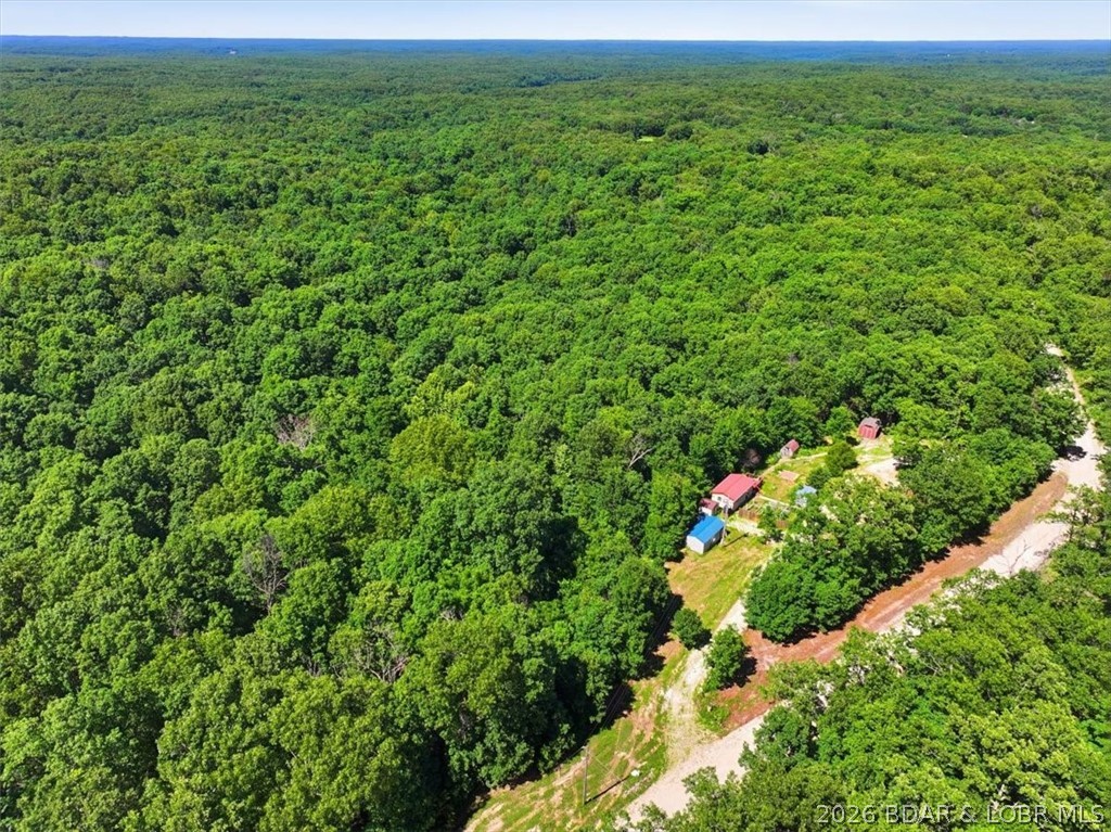 ULTIMATE ADVENTURE PROPERTY AND INVESTMENT PLAY. Escape to 9 acres of country freedom just 0.2 miles off Highway 135. Boasting independent access from two separate gravel roads, this unrestricted blank canvas can easily be split in half as a strategic investment lot or multi-unit development.

The property is fully set up for off grid living and features a minimalist tiny home, a large garden space, and a low pressure off grid water system. It is your own private homestead, but the real value is the explosive investment potential. Located just 2 miles from the Ozarks International Raceway and 20 minutes from the Loop Off-Road Park, this is an ideal hotspot for high demand vacation rentals, a tiny home community, or a camper park.

With absolutely no restrictions, you can split the land, build multiple cabins, or expand your investment portfolio near major Lake area attractions. Capitalize on the roaring tourism and motorsport crowds utilizing the unique dual road access to maximize your ROI. Don't miss this rare chance to divide, conquer, and build. Broker Owned.