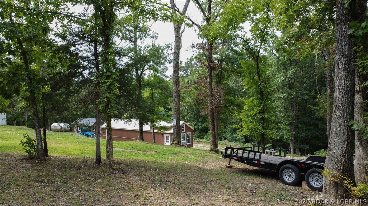 Outdoor enthusiasts, hunters and homesteaders—this one is for you! Set on 7.69 acres with a mix of wooded and cleared land, this newly completed one-bedroom, one-bath cabin offers the perfect place to live, hunt, explore or escape. Open concept kitchen, dining and family room with vaulted ceilings, a spacious bedroom, a full bathroom with laundry while the loft provides storage or additional non-conforming sleeping space. A second small cabin is wired and ready to be transformed into a bunkhouse, workshop or gear storage, with space to add a kitchen and bathroom. Improvements include a new well and new septic system. A wet-weather creek winds through the property, adding to its natural beauty and recreational appeal. Located just minutes from The Loop 2 off-road park and near a public boat ramp, this peaceful retreat offers easy access to side-by-side adventures, fishing and boating. Whether you envision a hunting camp, weekend getaway, small farm or private homestead, this versatile property is ready for your next adventure! Schedule your showing today!