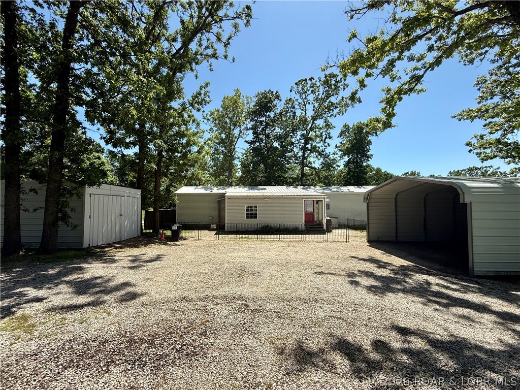 Usable acreage, outbuildings, and live/work potential all come together on this 4 acre property with Highway frontage. The 2 bed, 2 bath home features a comfortable layout, screened-in porch, and an additional office space if needed. Outside, you’ll find multiple amenities including tornado shelter, chicken house, greenhouse and garden area already started. One pasture includes large 3-bay metal barn, lean-to and carport all ready for your animals and storage. Next to the home includes a garage with concrete floor and electricity another carport for your vehicle and additional metal building for storage. Another added bonus is the most adorable 2023 She/He Shed that adds the perfect touch of charm ideal for hobbies, storage, gardening supplies or a quiet little creative escape. The land lays level with a walking path at the back of the property and peach and apple trees already started. With usable fenced acreage and 3 pastures cross fenced there is room for animals, tools, toys, or a home-based business, this property is ready for its next chapter. Come take a look today and see all the potential this property has.