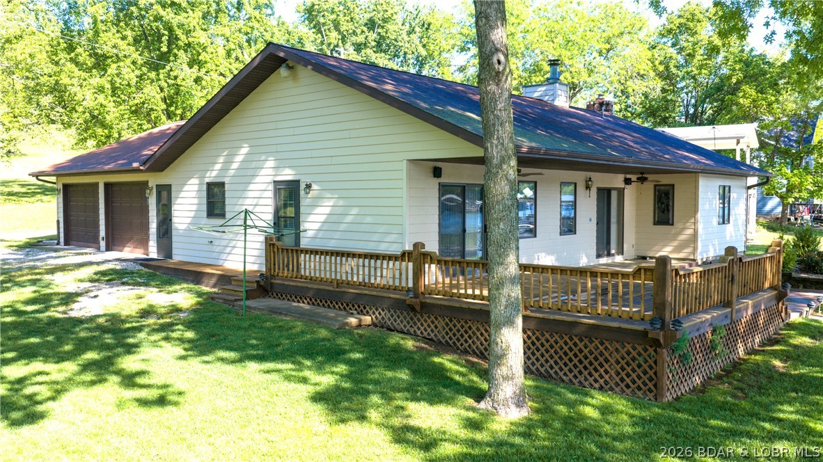 Do you need 1 level living on a nearly level lot?  Spacious living area with lakeview, open concept living dining & kitchen. Primary bedroom with lake view, walk in closet, and large bath. 2 additional guest bedrooms and full bath. Just off the kitchen is a large oversized 2 stall garage which is finished. There is a small office rm in the garage with utility rm.  Garage has a maintenance style deep sink, and you'll also find an additional stove for those busy holiday gatherings. This garage could easily transform into a recreation space when needed.  There is a sizable deck on the lakeside, just a couple steps up from the nearly level yard leading to the dock. There are sunscreens in the boat slip, which includes a boat lift. The boat in the slip will be included and is a 23 ft 87 Larson open bow. There is an open yard area next to this property, giving some privacy.  Across the street is an additional lot which is included.  Sellers are selling this home turn key, and this is an As Is sale, home furnishings, appliances and boat! Literally, you can bring your clothes and start your lake life!