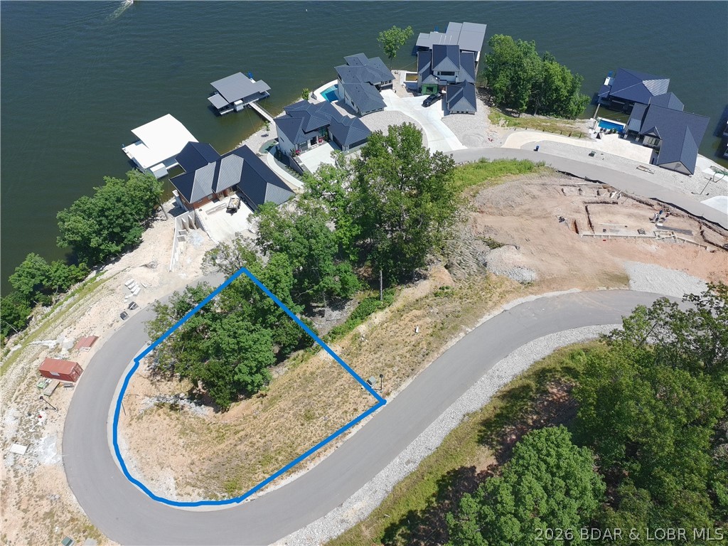 Lot 18 is now ready for you to build your dream home at one of the Ozarks hottest new subdivisions, The Waters. This lot also includes a 14x40 foot boat slip in the brand new community dock! You will also be able to purchase additional PWC slips in the community dock! This lot has a amazing view over looking the 3MM on the gorgeous Lake of the Ozarks. Located off of Hwy HH, you are just minutes from a multitude of lake bars, golf courses, and local hotspots. Don't miss your opportunity to build your LOZ dream house today!