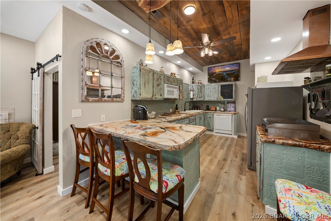 What if your lakehouse could help pay for itself? Live in one level, rent out the other, use both as separate vacation rentals or open it all up into one incredible lake retreat or full time home! Discover a rare blend of luxury, versatility & investment potential in this beautifully remodeled lakefront escape. Designed to function as two separate residences or one expansive year-round home, each level offers its own complete living space - ideal for generating rental income, hosting guests, or both! Step inside to a bright, open-concept interior featuring a natural gas fireplace, pool table, impressive chef’s kitchen & custom professional finishes throughout. The upper level offers a second stand-alone living area, while the spacious loft provides flexibility as a 7th bedroom, office or game room. Outside, a short walk leads to the 2-well private dock & everything Lake of the Ozarks has to offer. Enjoy vibrant sunsets & spectacular seasonal scenery from your own private lodge-like setting providing privacy when you want it and lakefront fun when you don't. This exceptional property offers the perfect combination of privacy, recreation, and income potential with NO HOA!