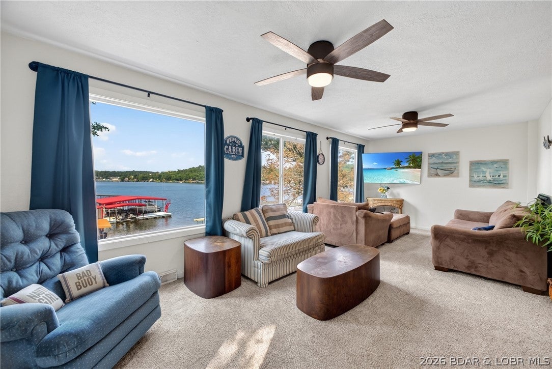 AMAZING LAKEFRONT $285K!!! Charming 2-bedroom, 1.5-bath lakefront getaway with breathtaking views on the Gravois Arm of the Lake of the Ozarks! Enjoy the expansive lakeside deck, oversized lot, and firepit for relaxing evenings. The shoreline offers a gradual walk to the water with deep water at the dock area, ideal for swimming, boating, and fishing. Inside you'll find fresh paint and new high-end luxury vinyl plank flooring & other updates. The lower level features a half bath, laundry, additional sleeping area, and ample storage. An added bonus is the existing Ameren dock permit. The dock currently on the adjacent property may be relocated to this lakefront, as it conforms to the current Ameren permit with the catwalk shortened to meet requirements. Located in the peaceful Golden Beach community, you're just minutes by water to popular waterfront restaurants, marinas, and attractions. Whether you're looking for a weekend retreat, vacation rental, or full-time lake home, this property offers the perfect blend of lake living, convenience, and spectacular views