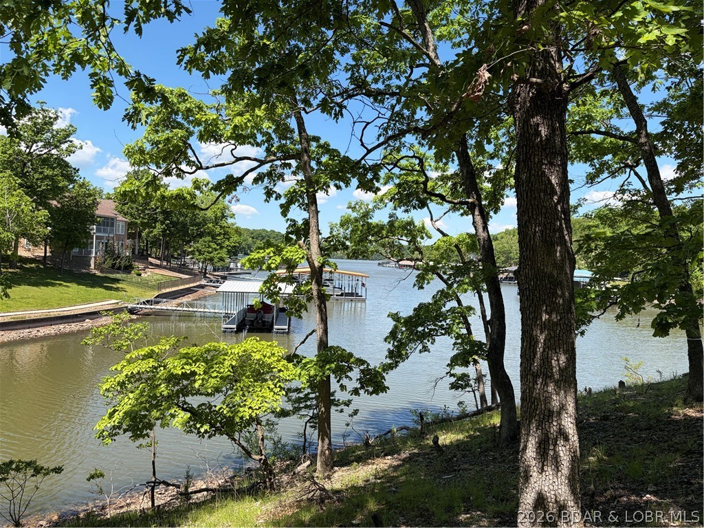 Discover the perfect setting for your dream lake home in the prestigious Porto Cima community at the Lake of the Ozarks. This beautiful waterfront lot offers a gentle, gradual slope to the water, making it ideal for easy access and endless enjoyment of lake living. Surrounded by mature trees, the property provides both privacy and a peaceful natural setting while still being close to all the amenities Porto Cima and The Lake has to offer. Whether you're looking to build a luxury retreat or a full-time residence, this lot combines breathtaking lakefront views with the beauty of the Ozarks.