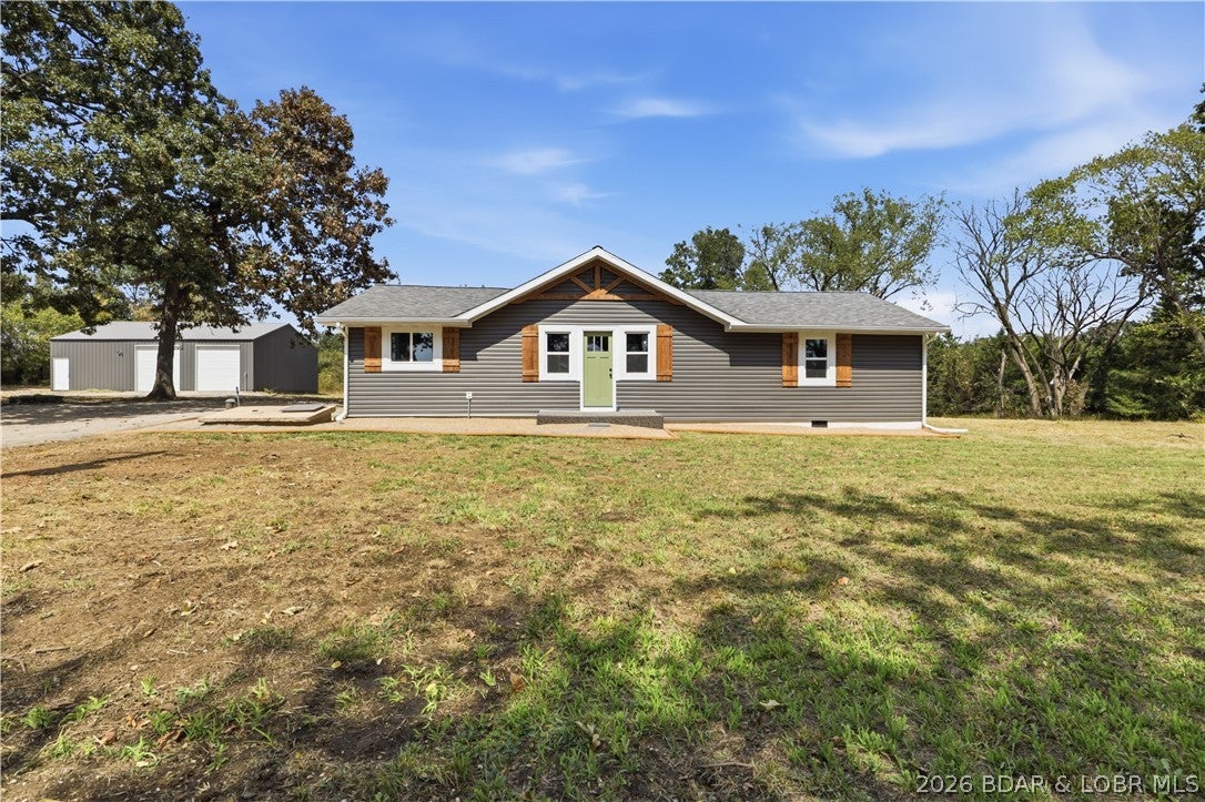 This is a wonderfully refurbished home that has been extremely tastfully done and includes a very large detached shop for the project person- THis home is set in the lovely countryside of Macks Creek, MO. The original was built in 1920 and then was added onto later. Detail-oriented craftsmen have taken it down to the studs in some areas, brought back some areas and reconfigured the whole house- what a gem. This property has character and is not a cookie cutter house. It has 1429 sq feet open plan with 3 bedrooms and 2 full baths and a laundry hookup . The kitchen is fabulous with all-new stainless appliances and lots of cabinets and countertop. Come take a look at the lovely countryside location and breathe in fresh air. 1.4 acre lot affords plenty of room for garden and or a few animals...The large 1200 sq ft shop has a concrete floor and electricity and opens up endless possibilities for the handiman or woman to explore their passion. Make your appointment today.