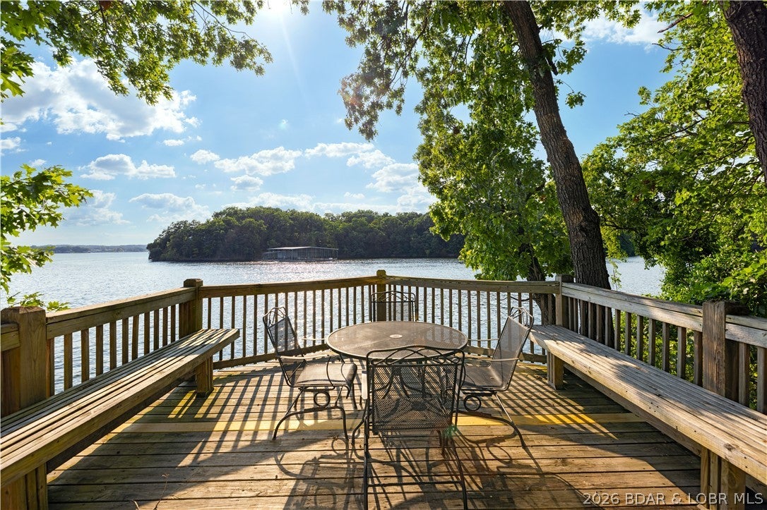 Experience lakefront living at its finest in this distinctive octagon-style home in Tree Top Subdivision! Offering 1,118 sq. ft. with 2 bedrooms and 3 full bathrooms, the home’s abundance of windows fills the interior with natural light while showcasing incredible views of the Lake of the Ozarks. The highlight is the lower-level deck perched at the water’s edge—an unforgettable setting for relaxing, entertaining and taking in the beauty of the lake. Surrounded by mature trees, this property provides a peaceful retreat with the water just steps away. Tree Top owners enjoy two community pools, along with access to all Four Seasons amenities. Whether you are searching for a full-time residence or weekend getaway, this rare lakefront home delivers the views, character and Lake lifestyle you have been waiting for!