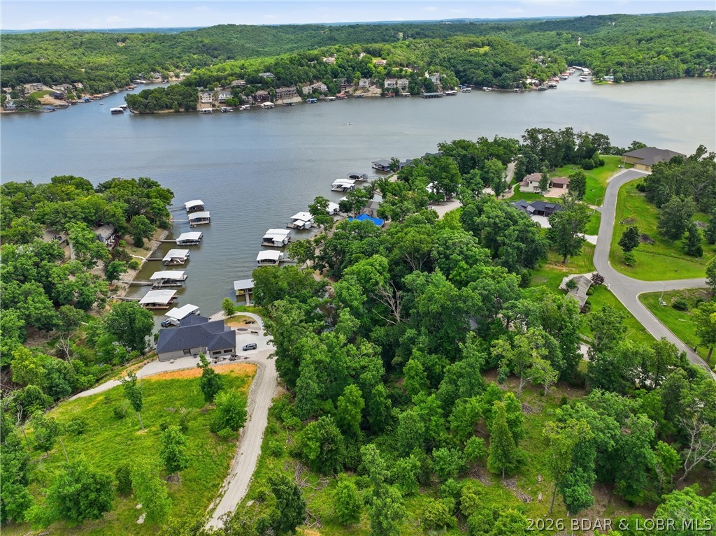 Experience lakefront living at its finest in this stunning 4-bedroom, 3-bath home nestled in the peaceful waters of Linn Creek Cove at the 31 Mile Marker of Lake of the Ozarks. Offering approximately 4,000 square feet of thoughtfully designed living space, this home is perfectly positioned to capture breathtaking lake views through dramatic floor-to-ceiling windows that flood the interior with natural light. The warm glow of the wood-burning fireplace creates an inviting atmosphere, while the serene setting offers the perfect escape from the everyday. Wake up to sparkling water views from the luxurious primary suite, complete with a spa-like bathroom and spacious walk-in closet designed to impress. Step outside and embrace the lake lifestyle with your own private dock and boat slip, making it easy to spend your days boating, fishing, or simply soaking in the beauty of the cove. Whether you're looking for a full-time residence or the ultimate waterfront retreat, this exceptional property delivers. Schedule your private showing today and discover everything this incredible Lake of the Ozarks home has to offer.