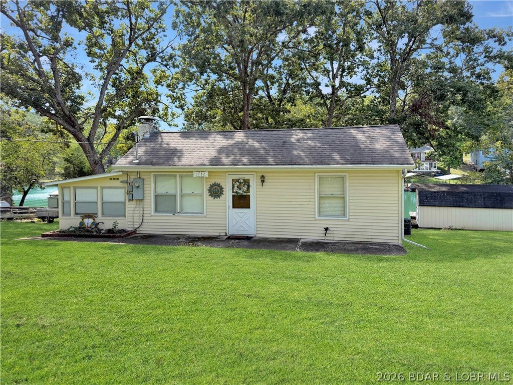 Affordable Lakefront Living at the 69 Mile Marker! Enjoy everything Lake of the Ozarks has to offer with this charming 2-bedroom, 1.5-bath lakefront home located in the desirable Lazy Acres community. Situated on 3 lots with approximately 103 feet of lake frontage, this property offers a level lot, plenty of parking, and a detached garage—giving you room for lake toys, vehicles, and guests!

Inside, you’ll find a cozy fireplace and a spacious sunroom that provides additional room to relax, entertain, or accommodate extra guests. Outside is where the lake life really begins! Head down to your 10x20 dock plus additional day dock and spend your days fishing, swimming, boating, or simply enjoying the water.

With no HOA fees, a great neighborhood, plenty of usable outdoor space, and convenient access to the lake, this property offers tons of possibilities. Whether you’re looking for a full-time home, weekend lake getaway, or a place where family and friends can gather, 1752 Sagrada Drive is ready for its next chapter.

103’ of lakefront. 3 lots. Level yard. Garage. Plenty of parking. Your own dock. Come see how affordable lake life can be!
