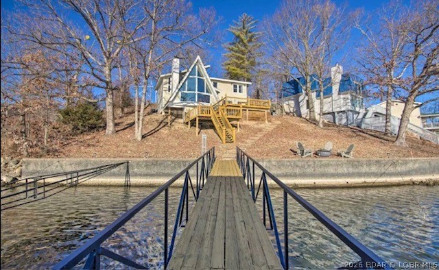 Back on the market with updates and a $10K flooring credit.  Stunning Lakefront Retreat located at the 1 MM in Lake Ozark. This beautifully updated home offers the perfect blend of modern design, comfort, and breathtaking lake views. Nestled in a protected cove with main channel views, this home is ideal as a forever home, vacation getaway or a profitable rental investment. Recently changed to a property management company the home has booked up quickly due to the unique traits of the home that make it more desirable when compared to other short term rentals. This profitable property is only being sold so the owner can help purchase a home for his parents who lost everything in a fire. 
Every detail has been thoughtfully designed - from the open-concept living area filled with natural light to the sleek finishes throughout. Step outside to your expansive lakeside entertainment area, perfect for hosting family and friends. Enjoy cozy evenings by the fire pit, soak in panoramic lake views, or have the best nights sleep when the time comes. This home has it all: location, cove protection, views, and a unique rental situation...  Don't miss this golden opportunity - come see it today