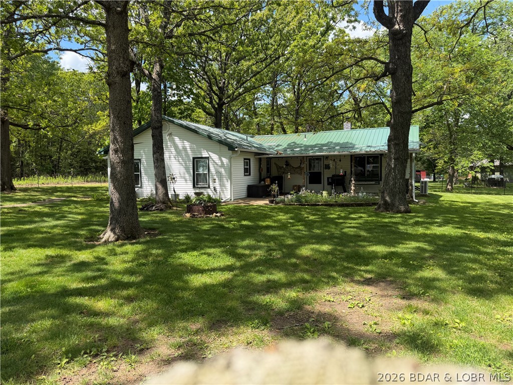 Move-in ready country home on 19.38 acres in Hickory County, Missouri! This updated 3 bedroom, 2 bath home features major improvements including new windows, new roof, updated wiring, and a new septic system, giving buyers peace of mind and modern comfort. The property offers a great mix of fenced pasture and wooded acreage, perfect for livestock, recreation, and wildlife. A beautiful spring-fed pond stocked with fish adds to the charm and provides a great place to relax or enjoy fishing. Outbuildings include a 2-car detached garage with workbench and storage area, a large pole barn for equipment and hay storage, plus a well house with an additional storage shed. This property is ideal for a hobby farm or anyone wanting to enjoy country living at its best with plenty of room for animals, equipment, and outdoor activities.