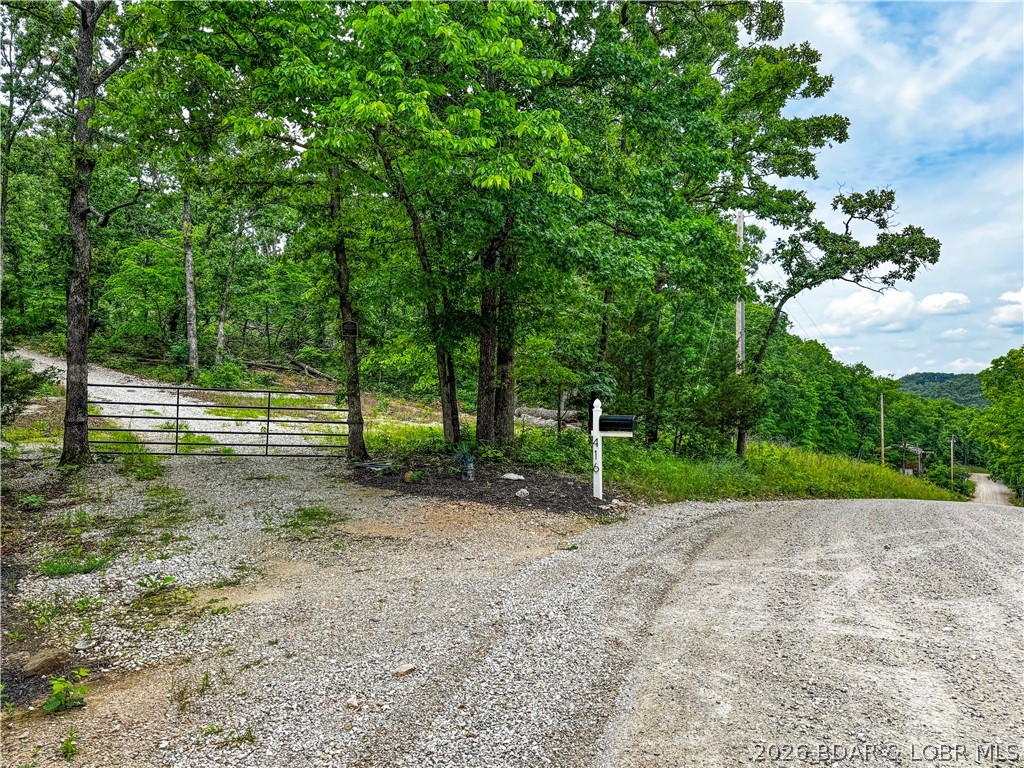 Escape to your own private retreat with this 21.48-acre tract in Roach. Tucked among the trees and surrounded by nature, this property offers a seclusion and accessibility. A gated entrance and established gravel drive lead to a cleared homesite where the previous owner parked a camper, creating an ideal setup for weekend getaways, hunting camp, recreational use, or your future dream home. Electric is already on site, saving time and expense as you plan your next project. The rolling wooded acreage provides plenty of room to explore, ride ATVs, hunt, hike, or simply enjoy the peace and privacy of the Ozarks. Even with the  secluded feel, you're just a short drive from Lake of the Ozarks access, dining, and amenities. Whether you're looking for a recreational retreat, a future building site, or an investment in land, this property offers endless possibilities on over 21 acres of beautiful Missouri countryside.