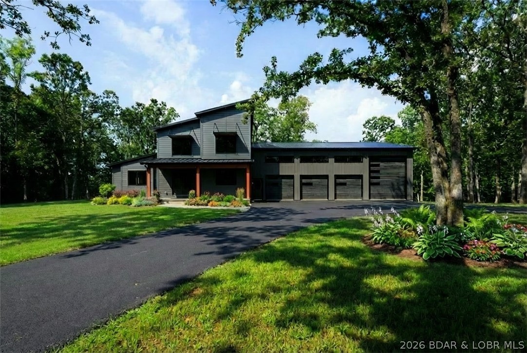 Discover a one-of-a-kind residence where modern architecture harmonizes and craftsmanship. This stunning home sits on 5 acres offering 4 beds, 6 baths along with a 2,300 sq.ft. garage, complete with heated floors and A/C. Inside and experience an open-concept living space with 24ft vaulted ceilings in the great room. Oversized Low-E Andersen windows flood the home with natural light while offering serene woodland views. Crafted with only the highest quality materials, the home features elegant wood floors, soundproofed bedrooms and baths, 8ft solid core interior doors, and seamless flush style trim exuding craftsmanship. A chef’s inspired kitchen complete with handcrafted cabinetry, sleek black stainless steel appliances, and a hidden walk-in pantry for ample storage. Retreat to the master suite where you’ll find a stand alone soaking tub, a luxurious walk-in shower and spacious custom walk-in closet. This home is design with quality and comfort in mind. The perfect sanctuary for modern living and privacy. Additional features includes proximity to schools, shopping, parks, and major highways. Additional acreage for sale with water and electricity.
