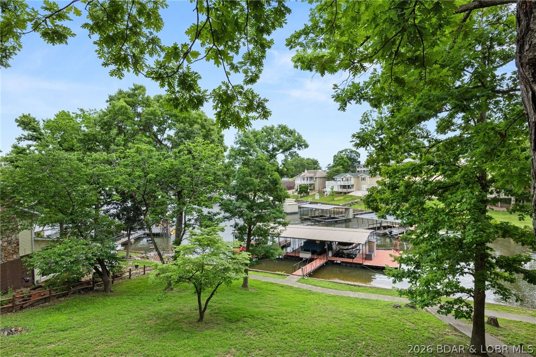 Lakefront living at its finest in prestigious Millstone Estates! This well-maintained 3-bedroom, 3-bath home offers approximately 2,146 square feet of living space and features a durable metal roof, cozy wood-burning fireplace in the living room, and beautiful lake views. Enjoy easy waterfront access to community dock with a boat slip, lift, swim platform & ladder and one PWC drive on hoist. An additional boat slip in a separate dock is available for purchase, providing even more convenience for lake enthusiasts. Don’t miss this opportunity to own a prime lakefront property in one of the area’s most desirable communities.