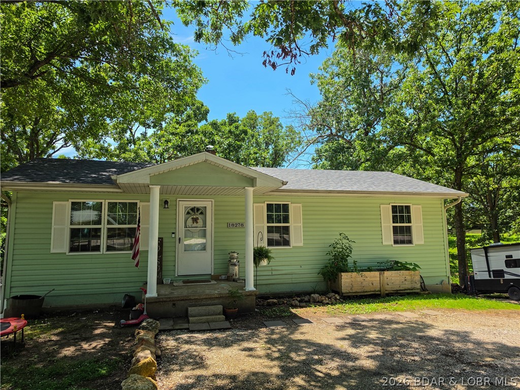 This home combines comfort, functionality, and a great location—don't miss the opportunity to make it yours! This charming home features 3 bedrooms and 1.5 bathrooms and sits on a large lot with a fenced backyard for all your four legged family members. The mature trees provide plenty of shade in the yard or you can enjoy the covered deck or the covered patio. These areas offer some fabulous extended space for entertaining. And when everyone is gone, kick back and enjoy the lovely setting just minutes from town and only a few more minutes to public boat access at the Lake. The main level has a large family room full of windows for natural light with a door to the deck. The dining, kitchen and full bath as well as three bedrooms complete the main level. On the lower level there's a bonus room, storage room (or could be craft room), laundry, half bath, garage and shop area. The basement garage offers convenient parking along with additional space for abundant storage. Located just outside the city limits, this property allows you to enjoy a more peaceful outdoor setting while still being close to town and all its conveniences.