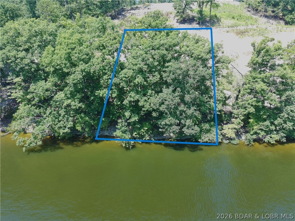 If you've been dreaming of building your own place at the Lake of the Ozarks, this waterfront lot is one you'll want to see. Offering approximately 95 feet of shoreline, this property provides the perfect setting to create your ideal lake retreat, whether you're planning a full-time residence, vacation home, or investment property. Enjoy beautiful water views, easy lake access, and plenty of room to design a home that takes full advantage of everything lake living has to offer. Spend your mornings on the dock with a cup of coffee, your afternoons out on the water, and your evenings taking in the peaceful views. Conveniently located with access to all the dining, entertainment, and recreation the Lake of the Ozarks is known for, this lot offers the opportunity to build exactly what you've been looking for. Waterfront opportunities with 95 feet of shoreline don't come along often—don't miss your chance to make this one yours.