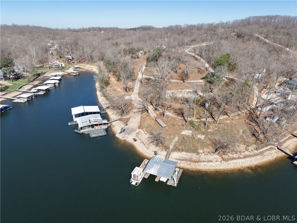 Incomparable!  Unlimited possibilities!  Unbelievable Views!  This historic campground is located at the 3.5 mm in Jackson Branch Cove, formally known as Timber Shore Estates and Endless Trails Campground. 107 +/- acres of property and 1200 + ft of shoreline, a natural beach, and a large commercial concrete boat ramp add to the unlimited possibilities for this property.  Located in Miller County so there are no zoning limitations on the use of this property. Perfectly suited for a private estate, condominiums, subdivision, tiny homes, restaurant and bar, RV campground, and boat dock manufacturers. Less than a 15 minute blacktop drive to the property from Bagnell Dam. Ask about flexible seller financing available to qualified buyers.