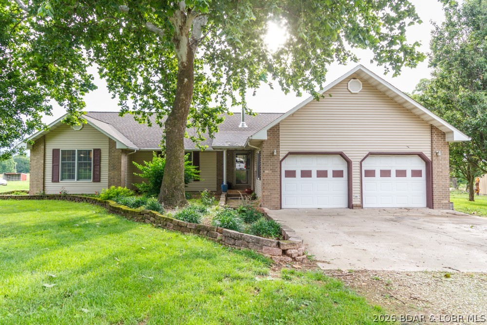 Nestled on 22 acs m/l, this beautifully maintained property offers the perfect blend of comfort, functionality, & rural charm. Inside, you'll find 1,834 sq. ft. of thoughtfully designed living space featuring a desirable split-bedroom floor plan with 3 beds, 2 full baths, & an attached 2-car garage complete with an epoxy-coated floor. The home offers several standout features, including a hall closet that doubles as a coded gun safe and a recently installed Vermont Castings Encore wood stove, providing both warmth and rustic character. The impressive 50' x 60' barn features a gravel floor & ample space for hay, feed, & machinery storage. Additional outbuildings include a 20' x 12' storage building with a concrete floor, as well as an additional 8' x 12' storage shed for even more versatility. The fenced acreage includes an established garden area, chicken coop, mature trees, abundant wildlife, & a beautiful pond, creating an ideal environment for sustainable country living. Numerous updates provide peace of mind, including a new roof in 2021, new siding installed in 2023, a new exterior HVAC unit in 2021, and new flooring throughout the home.