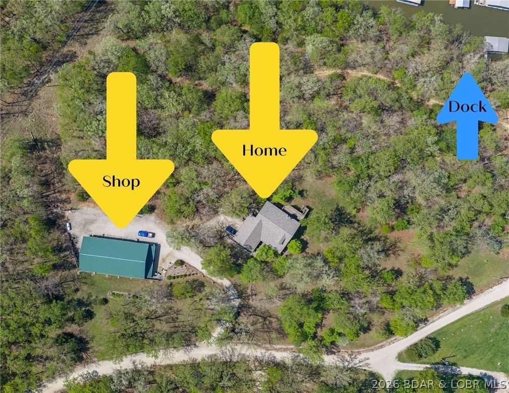 Privacy, acreage, and lakefront living come together at this exceptional property in Sunrise Beach at the 25 Mile Marker of Lake of the Ozarks. 8 private acres with 230 feet of cove-protected shoreline, this spacious home offers the perfect setting for full-time living, a family retreat. Designed with main-level living, the home features 3 bedrooms, 2 full baths, 1 half bath, two fireplaces, expansive living spaces, and a finished walkout lower level ideal for entertaining or accommodating guests. Step outside to enjoy the peaceful surroundings from multiple decks, a covered patio, and inviting porch, all surrounded by mature trees and abundant wildlife. The property also includes a large detached shop 3,360 sq. ft. complete with office and bathroom, providing endless possibilities for hobbies, storage, or a home-based business. Down by the water, you'll find a private covered dock with a 12' x 28' slip, boat hoist, swim platform, and ladder, making it easy to enjoy everything Lake of the Ozarks has to offer. Rarely do properties offer this combination of privacy, acreage, waterfront, and convenient Sunrise Beach location.