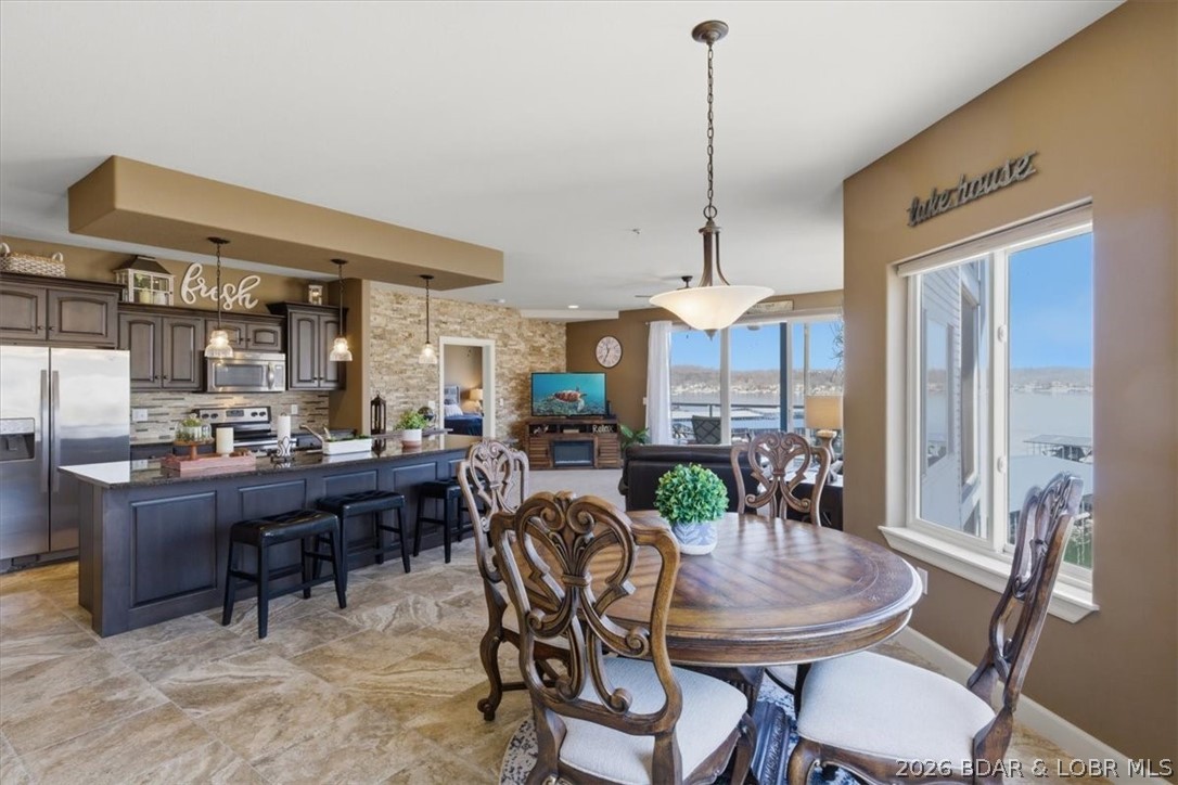 Welcome to Blue Anchor Bay, a highly sought-after lakeside community offering exceptional lake living. This condo includes a 12 x 32 boat slip and a new roof, providing both value and peace of mind. Inside, soaring ceilings and an open-concept layout create a bright, spacious feel, enhanced by high-end finishes, custom cabinetry, and a stylish stone backsplash. The kitchen features an island and breakfast bar, perfect for casual dining and entertaining. The master suite offers stunning lake views, a walk-in shower, dual vanities, and elegant stone tile flooring. Enjoy the convenience of elevator access for easy entry. Community amenities include two pools, two swim platforms, a fenced playground, and scenic boardwalks. The dock is well equipped with water, electricity, security cameras, and a fish cleaning station. With manicured grounds and a pet-friendly setting, Blue Anchor Bay offers an unmatched lakefront lifestyle designed for both relaxation and adventure.