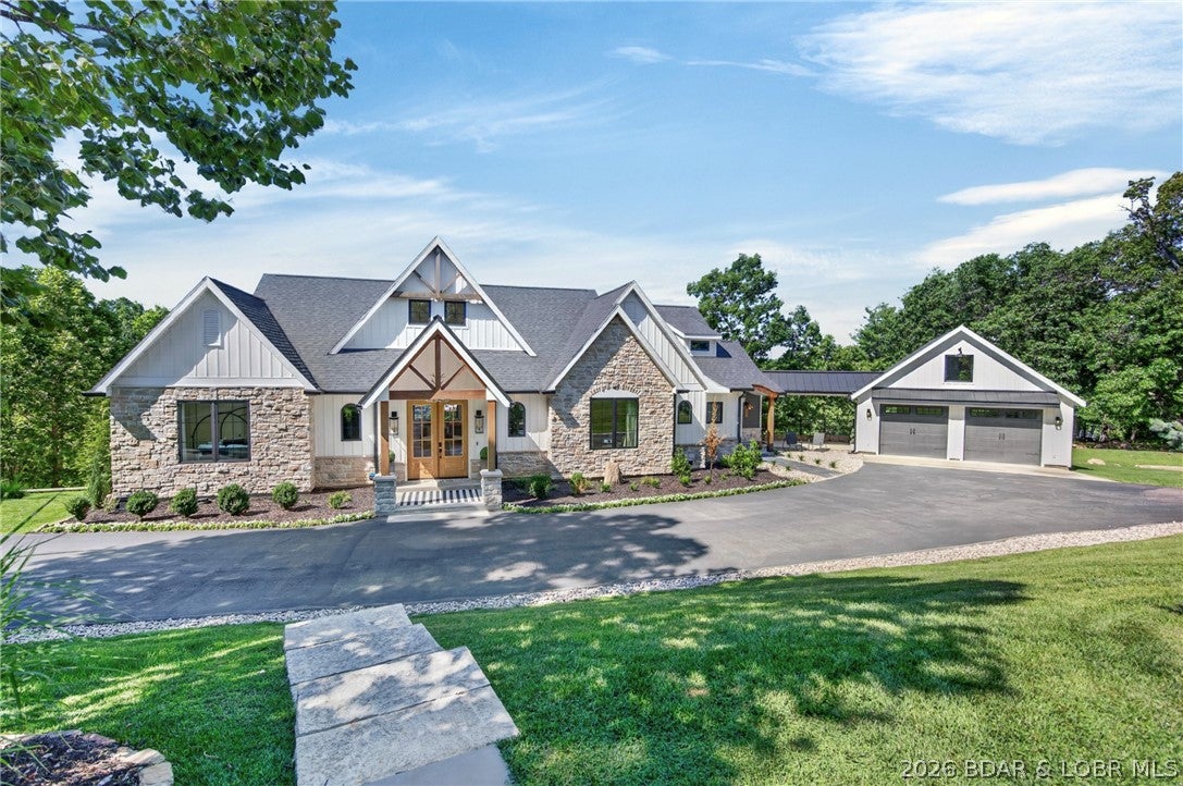 Elevated lakefront living in this custom-built waterfront retreat, where luxury finishes, thoughtful design & effortless access to the water come together. Offering 6 bdrms & 4.5 bths, this home showcases beautiful craftsmanship, custom cabinetry & elegant arched doorways adding timeless character. A stunning wall of windows frames beautiful lake views, filling the home w/ natural light. Designed for entertaining & making memories, the spacious LL features full bar & plenty of room for holidays & weekends w/ family & friends. Outdoor living is equally impressive w/ screened-in porch, expansive decks & lakeside fire pit. A standout feature is the gentle access path to your private dock. Load up the side-by-side & head straight down to the water—no stairs to climb, no long walk back up. Simply load up, head to the dock & enjoy the lake w/ ease. W/ generous acreage, beautiful waterfront, ample parking including a 2-C garage & extensive driveway space, this property offers the ideal blend of land, luxury & lake living. Conveniently located near restaurants, golf courses & attractions, this is more than just a home—it's a place to gather, relax & enjoy everything lake life has to offer.