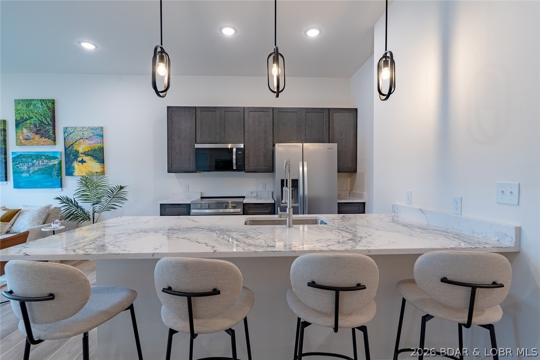 Only two first-floor units remain at this price! Experience refined lake living in this brand-new Ember Ridge condo, featuring durable steel-frame construction and quality craftsmanship. This 3-bedroom, 3-bath residence offers an open floor plan designed for comfortable everyday living and effortless entertaining. Enjoy beautiful lake views, true waterfront living, and convenient elevator access. Ideal as a full-time residence, weekend getaway, or vacation home. Located just minutes from popular waterfront restaurants and attractions, it's the perfect place to gather with family and friends or simply relax by the water. Photos are of Model Unit #205.