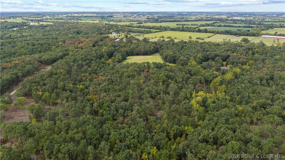 Tucked away just 4/10 of a mile off Highway 52, this exceptional 17.3-acre property offers the perfect blend of accessibility, privacy, and freedom. Situated near Big Rock Road directly behind the church and featuring a newly constructed access road, the land boasts a highly desirable level-to-moderate terrain that is ready for your vision. Best of all, there is no HOA to restrict your plans, giving you complete control over your estate. Enjoy the peace and quiet of a secluded rural setting while remaining just a convenient 10-minute drive from the heart of Eldon.