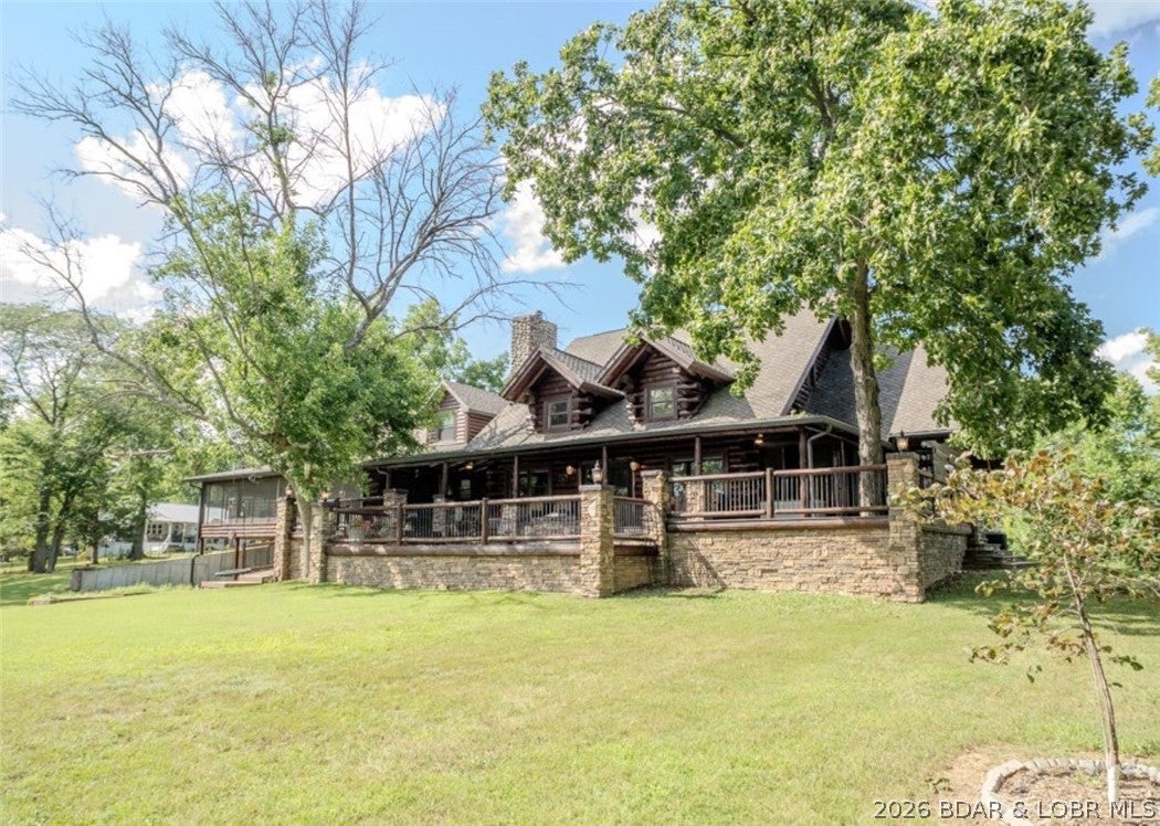 Breathtaking lake views from every window of this exquisite 6-bedroom, 7.5-bath estate, boasting over 5,000 square feet of luxury living & an unrivaled 900 feet of lake frontage encircling three sides of the property. The home features an expansive wraparound deck, a screened-in entertaining area, & two private docks—one with dual boat lifts and the other with a single lift—providing unmatched access to the water. Inside, three elegant fireplaces, dual kitchen areas, & a thoughtfully designed, custom gourmet kitchen outfitted with stainless steel appliances, quartz countertops, custom cabinetry, a gas range with integrated grill and cutting board, & a spacious walk-in pantry. Entertain effortlessly with multiple ovens, ranges, refrigerators, and icemakers—all included with the home. Two-car attached garage, a 30x50 outbuilding/workshop, and an adjoining five-car garage, offering ample space for vehicles, hobbies, or storage. Negotiable furnishings, make it move-in ready for the discerning buyer. Perfectly situated just off paved roads only five minutes from town and shopping. Schedule your private tour today and experience the luxury and lifestyle this home has to offer.