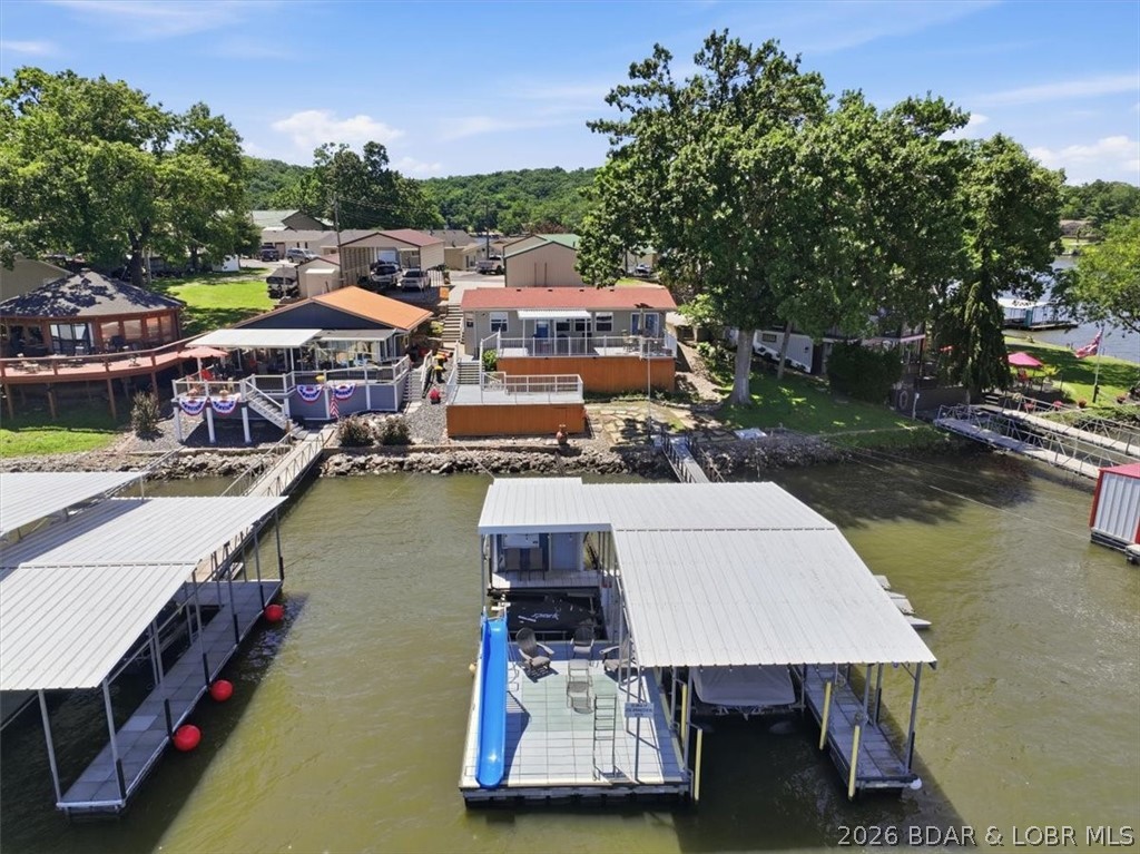 Just bring your swimming suit and start enjoying lake life! One level living, tastefully remodeled and furnished with main channel views plus deep water and only a few steps to the dock, this home is conveniently located at the mouth of Frankie and Louie cove giving access to all of the entertainment venues. This 3 bed, 2.5 bath cottage style home checks off all the boxes with multiple outdoor decks and only a few steps to your private dock. The dock is the perfect place to hang out all day including a 12x32 slip with hoist, PWC slip and hoist, swim platform with slide, wet steps and a dock bar with storage. A detached garage provides extra parking. Nightly rentals are NOT allowed but this is a rare lakefront package under $600,000!  Don't wait because there is nothing else like this and it will go FAST!!