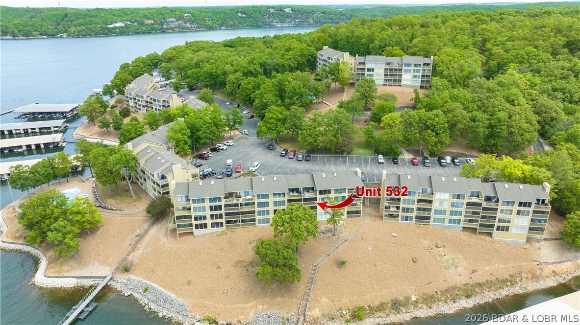 Experience lake living with this fully turn-key 2-bedroom, 2-bath condo in Bay Point Village at the 24 MM of the Osage Arm. Offering 950 square feet of well-maintained living space, this walk-in unit features only one step from parking to the front door, making access simple and convenient. Enjoy beautiful lake views from your private retreat, along with a 10x24 boat slip included in the sale for easy days on the water. Bay Point Village offers a fantastic lineup of amenities, including a lakeside pool, clubhouse, boat trailer parking, playground, cable service, and designated pet walking areas. Conveniently located just minutes from popular waterfront and roadside destinations such as Redhead Lakeside Grill, Shorty Pants Lounge & Marina, and Margaritaville Lake Resort Lake of the Ozarks. By water, you'll also enjoy quick access to Paradise Tropical Restaurant & Bar. Whether you're searching for a full-time residence, weekend getaway, or income-producing investment, this lakefront condo offers the perfect blend of comfort, convenience, and the Lake of the Ozarks lifestyle.