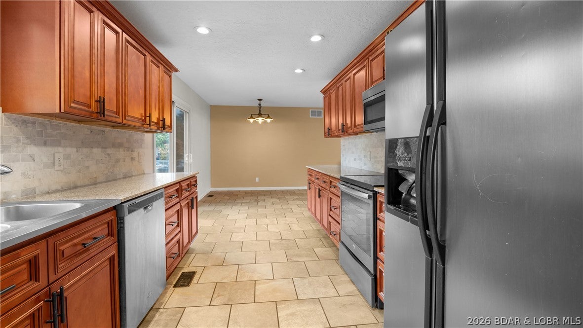 Welcome to 81 Ravenwood Drive—a hard-to-find opportunity for comfortable one-level living, privacy, and an attractive price point in Camdenton. Priced at just $264,900, this 3-bedroom, 2-bath ranch offers nearly 1,400 square feet with an open layout that makes daily life simple and entertaining comfortable. The spacious kitchen and dining area flow naturally into the living space, with every bedroom located on one level. Step outside to a level, partially fenced backyard with room for pets, play, gardening, grilling, or quiet evenings under the trees. The lot offers a welcome sense of privacy while keeping you close to Highway 5, Camdenton, shopping, dining, schools, and the recreational lifestyle of Lake of the Ozarks. A two-car attached garage, generous driveway parking, central sewer, community water, deck, patio, and practical updates add everyday value. Whether you are searching for an affordable primary residence, weekend base, or low-maintenance investment, this home deserves a close look. Space, a fenced yard, privacy, and location at this price are not easy to find. Schedule your private showing today and see how easily 81 Ravenwood Drive could fit your next chapter.