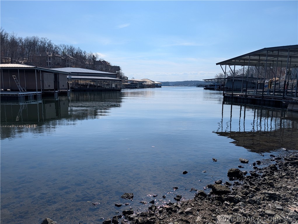 An impossible entry point into the Lake’s crown jewel. 137 Cliffstone offers a once-in-a-lifetime opportunity to build your dream home in The Villages at Shawnee Bend—the premier luxury waterfront enclave at Lake of the Ozarks. While neighboring homesites routinely command over $2M, this exceptional lot grants you access to an ultra-exclusive community defined by magnificent multi-million dollar estates for a fraction of the cost. Pass through the Lake’s most spectacular entrance, featuring a signature stone bridge and cascading waterfall, to discover a neighborhood built for discerning tastes. Enjoy unmatched amenities, including a clubhouse, pavilion, playground, pool, pickleball, and tennis courts. Total peace of mind is built-in with underground utilities, providing elite weather resilience and clean architectural lines. The compromise? A specific dock envelope. However, it comfortably accommodates a desirable 14x35 single-well slip—perfect for a lake cruiser. You retain the prestigious address, world-class lifestyle, and true lakefront access for under a million dollars. Bring your builder and secure the ultimate value in high-end living before it’s gone.
