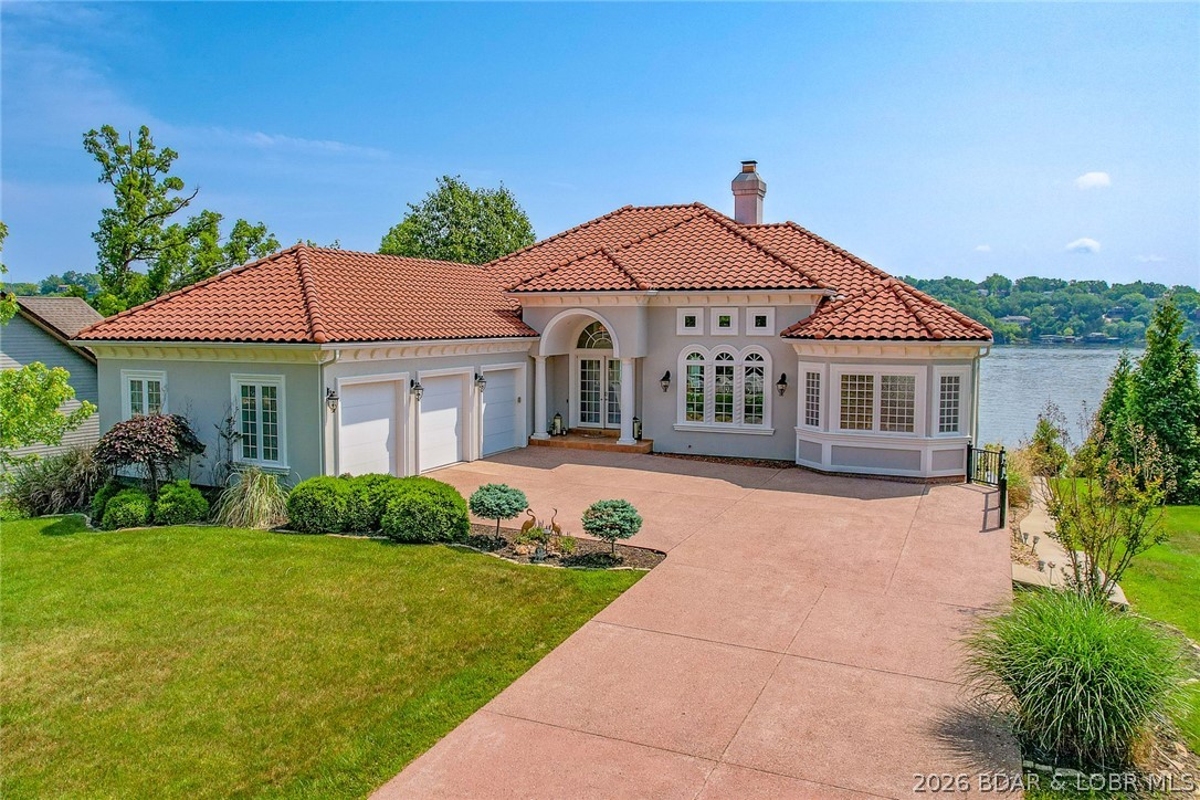 Welcome to 764 Via Del Lago in Porto Cima, set along the 16MM of the main channel with wide, unobstructed lake views. This 5,725 sq ft home offers a rare combination of privacy, quality, and thoughtful design in one of the lake’s most sought after communities. Inside, cathedral ceilings and expansive windows bring in natural light and frame the water from nearly every angle. The HMI custom fireplace anchors the main living space, while the layout flows easily to outdoor living areas designed for both relaxation and entertaining.

The lakeside pool and hot tub sit right at the water’s edge, creating a true resort feel. Four of the six bedrooms are lakefront suites with direct access to the veranda, giving guests their own private retreat. The lower level is built to gather, complete with a full wet bar, game room, and walkout access to the pool deck. Practical features include a tile roof with lifetime warranty, stucco exterior, flat driveway, sprinkler system, and 130 feet of shoreline already set up with electric and water for a dock. Located in Porto Cima, you’re minutes from golf, dining, and club amenities, while still enjoying a quiet, tucked away setting on the water.