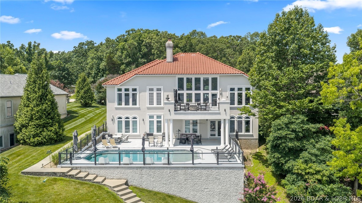 Welcome to 764 Via Del Lago in Porto Cima, perfectly positioned on the 16MM of the main channel with breathtaking, unobstructed lake views. This exceptional 5,725 sq ft waterfront home offers 6 bedrooms, including 4 lakefront suites with private access to the lakeside veranda. Soaring cathedral ceilings, walls of windows, and an HMI custom fireplace create an unforgettable first impression, while the full wet bar, game room, and walkout lower level were designed for effortless entertaining. Outdoors, enjoy a resort style lakeside outdoor pool, 130 feet of shoreline, and electric and water already in place for your dock. Additional features include a lifetime warranty tile roof, stucco exterior, flat driveway, and sprinkler system. Ownership includes Four Seasons POA amenities featuring multiple outdoor pools, indoor pool, tennis and pickleball courts, boat ramps, stocked fishing lakes, campground, parks, walking trails, dog park, community center, fitness center and year round social events, all just minutes from The Club at Porto Cima, championship golf courses, and waterfront dining.